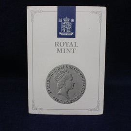 Royal Mint packaging with a profile of a queen and their logo on a dark background