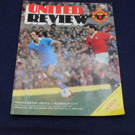 Manchester United vs Norwich City match program cover with two players on a blue background