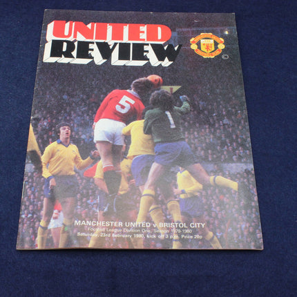 Soccer match program with players and Manchester United logo on a dark background