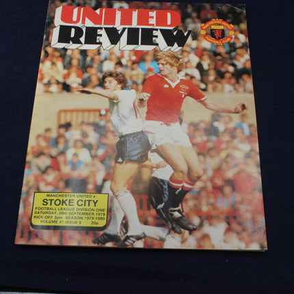 Manchester United vs Stoke City football match program cover with players in action.
