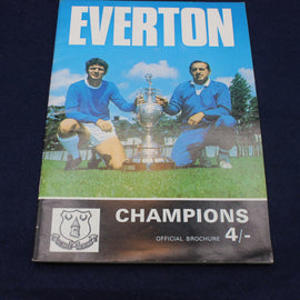 Vintage Everton football club official 1970's champions brochure with two players and a trophy on a grass field.