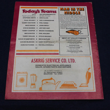 Vintage sports program with team names and advertisements on a dark background