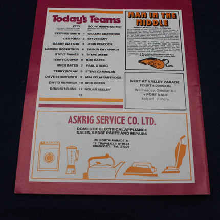 Vintage sports team sheet with advertisements on a red background