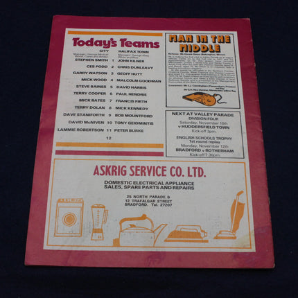 Vintage sports program with text and advertisements on a dark background