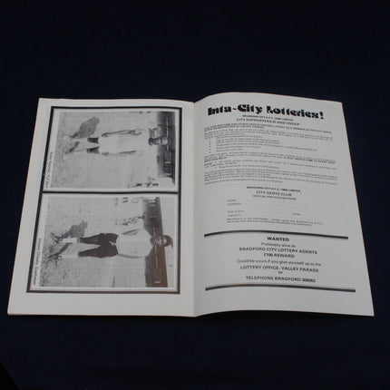 Open book with black and white images and text on a dark background