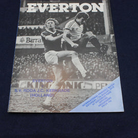 Soccer match program featuring two players in action with 'Everton' branding.