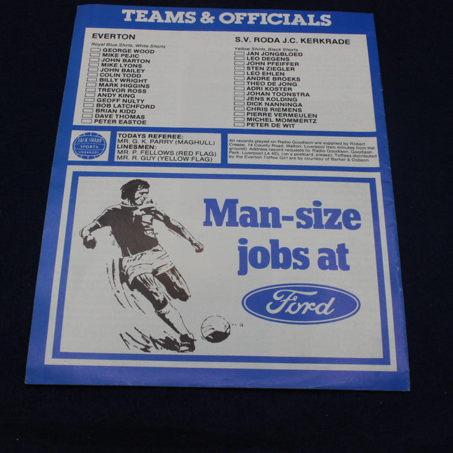 Soccer program with team and officials list, Ford advertisement, and player illustration on a dark background