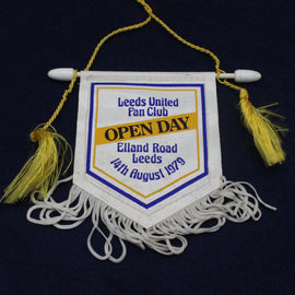 Leeds United Fan Club Open Day banner with tassels on a dark background