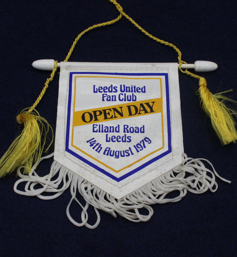 Leeds United Fan Club Open Day banner with tassels on a dark background