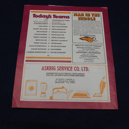 Sports team sheet with advertisements on a dark background