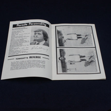 Open book with black and white text and images on a dark background