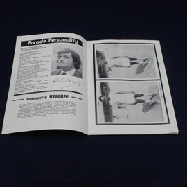 Open book with black and white text and images on a dark background