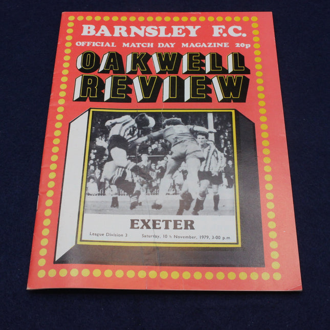 Cover of Barnsley F.C. 'Oakwell Review' magazine featuring a football match image on a dark background.