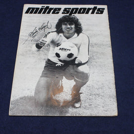 Vintage Mitre Sports promotional poster with a soccer player holding a ball on a dark blue background