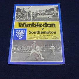Vintage football programme for Wimbledon vs Southampton match on a dark background