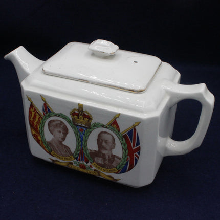 White teapot with royal portraits and flags on a dark background