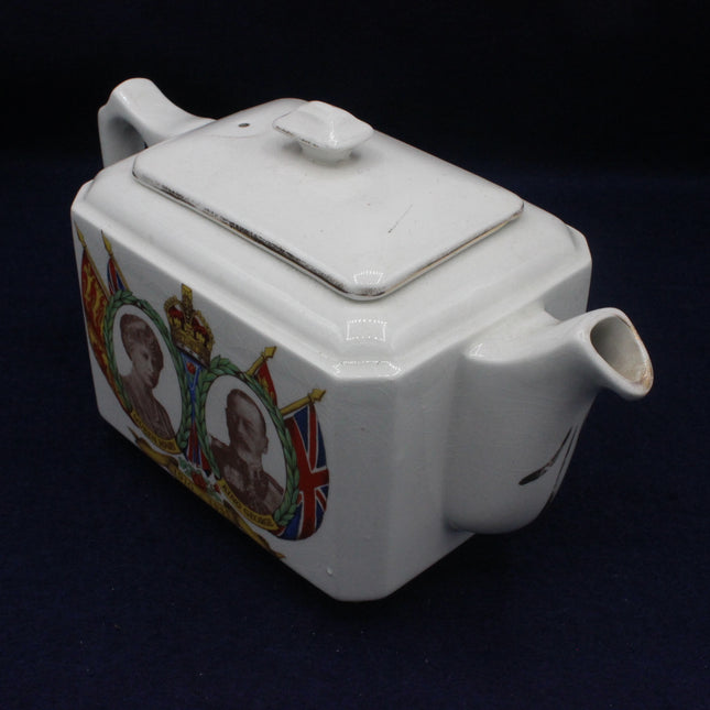 White teapot with decorative elements on a dark background