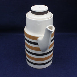 Ceramic pitcher with striped design on a dark blue background