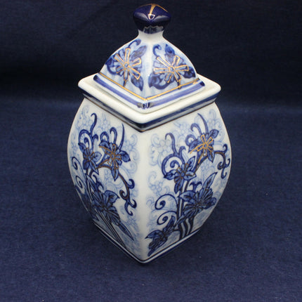 Decorative ceramic jar with blue floral patterns on a dark background