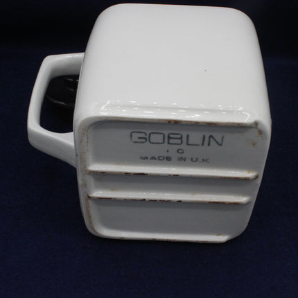 White ceramic item with 'Goblin' branding on a dark background