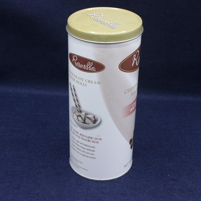 Canister of chocolate cream filled rolls with a gold lid on a blue background