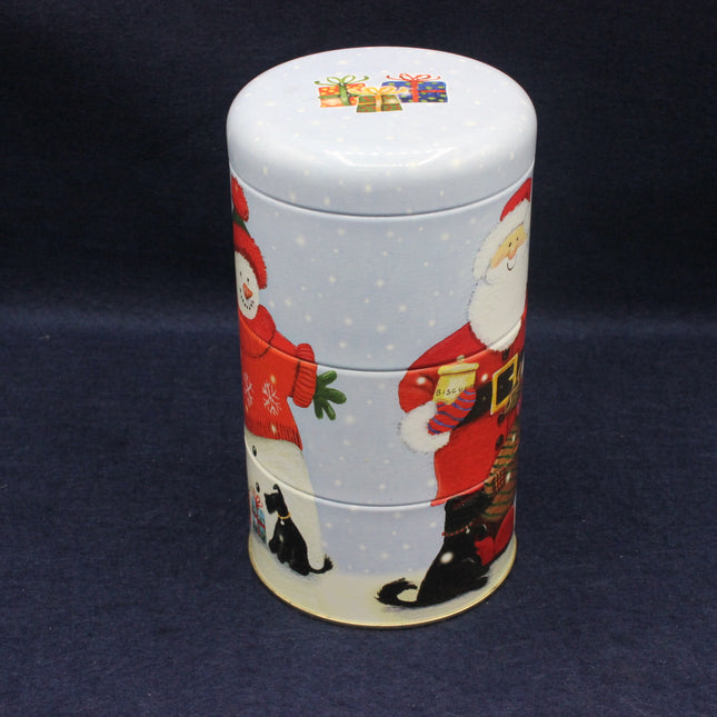 Decorative cylindrical tin with Santa Claus design on a dark background