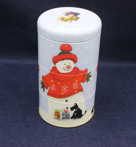 Decorative cylindrical container with a snowman design on a dark blue background