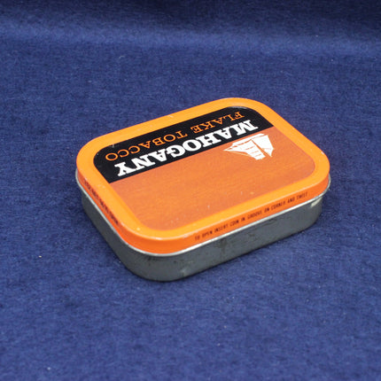 Mahogany Flake Tobacco tin on a blue background