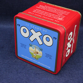 Red Oxo tin box with blue label on a dark blue background