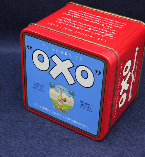 Red Oxo tin box with blue label on a dark blue background