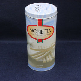 Empty canister of Monetta Luxury Cream Wafers on a dark blue background