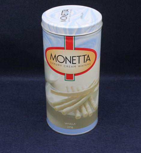 Empty canister of Monetta Luxury Cream Wafers on a dark blue background