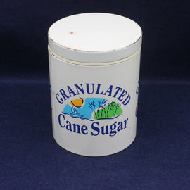 White container labeled 'Granulated Cane Sugar' on a dark blue background