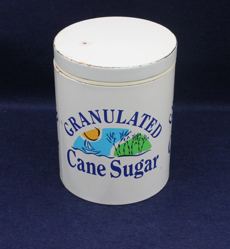 White container labeled 'Granulated Cane Sugar' on a dark blue background