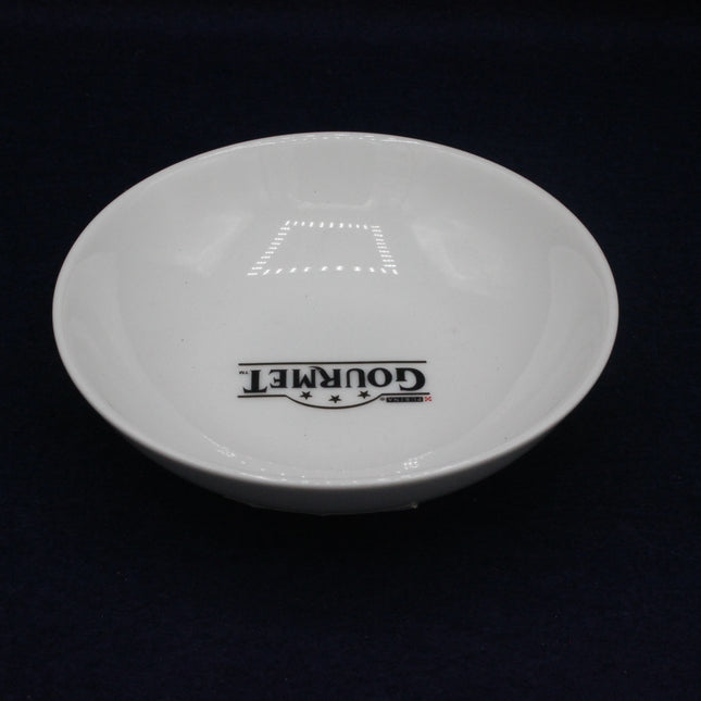 White plate with 'Gourmet' branding on a black background