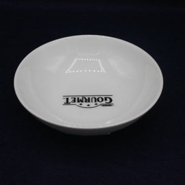 White plate with 'Gourmet' branding on a black background