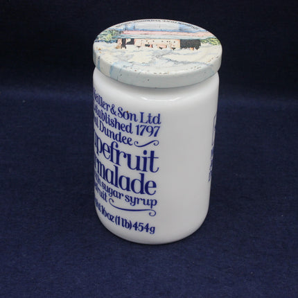 White jar with blue text on a dark blue background