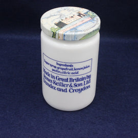 White jar with decorative lid on a dark blue background