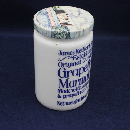 Jar of James Keiller grapefruit marmalade with decorative lid on a dark background