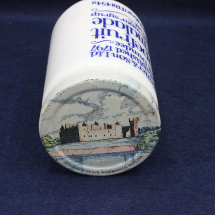 Ceramic coaster with castle illustration and text on a blue background