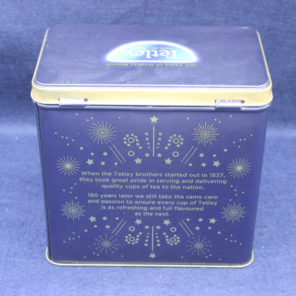 Blue tea tin with star patterns and text on a blue background