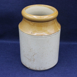 Ceramic jar with brown top and white body on a blue background