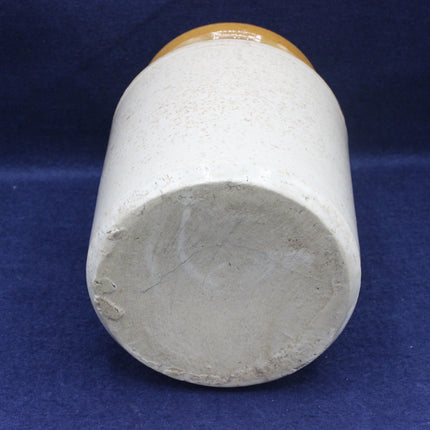 Cylindrical pot with a brown top on a blue background
