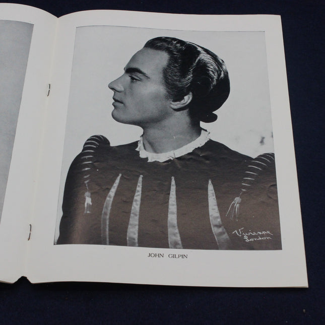 Black and white portrait of a person in historical attire on an open book.
