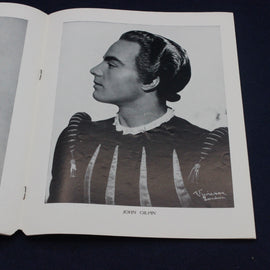 Black and white portrait of a person in historical attire on an open book.