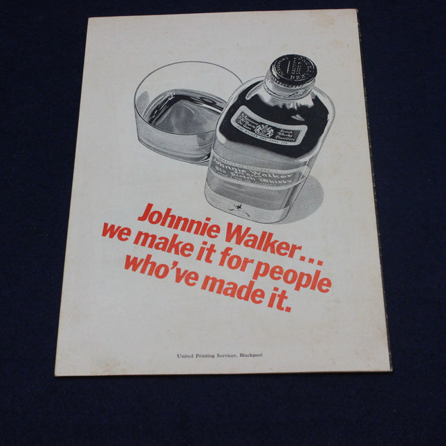 Johnnie Walker advertisement with bottle and glass on a dark background