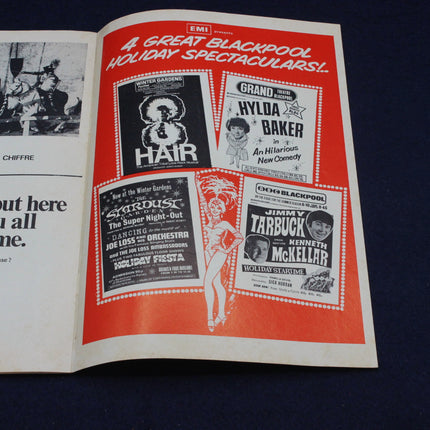 Open book with vintage Blackpool holiday spectaculars advertisement on a dark background