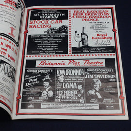 Open book with vintage advertisements for stock car racing, beer, and theater performances.