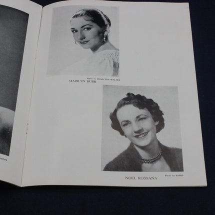 Open book with black and white portraits of two women on a dark background