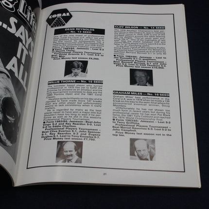 Open book with pages showing text and black and white photos of people, likely from a magazine or newspaper.